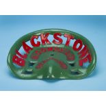 A vintage cast iron tractor seat by Blackstone & Co, painted in green and red