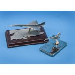 Two modern Concorde desk models, one by English Miniatures on wooden base, and a chromed example,