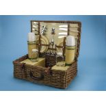 A 1960s picnic hamper for four, made by Corale, with contents of yellow plastic plates and cups