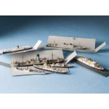 Seven waterline models of ships and boats, one Bassett-Lowke of a cruise liner, another of Automedon