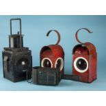 Four vintage transport and related lamps, two red signalling examples, one large black railway