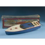 A 1930s Meccano Hornby Speed Boat, with white deck and blue hull, appears to run, with box and