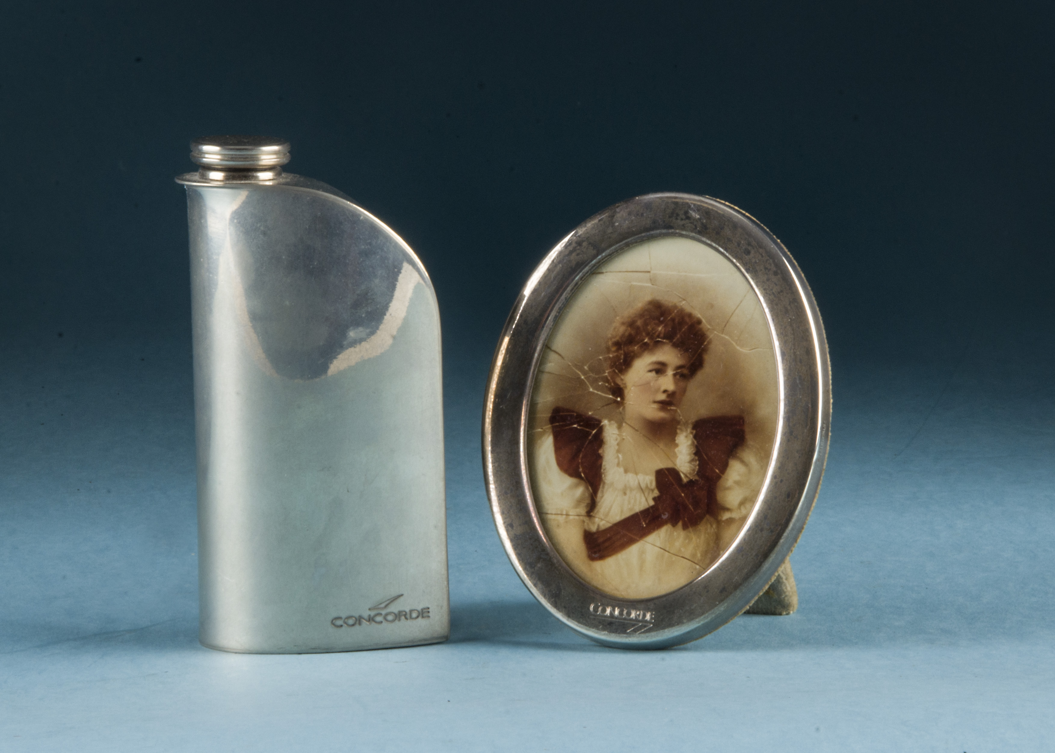 A 1990s silver oval photograph frame from Concorde, together with a silver plated Ergo Flask by