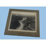 A 1930s silver gelatin photograph, airside image of a Tiger Moth or similar biplane flying over