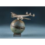 A 1950s aluminium Air France desk decoration, the Constellation aircraft on painted and gilt globe