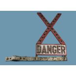 A vintage enamel and catseye junction crossing road sign, having "X" above word Danger, with post