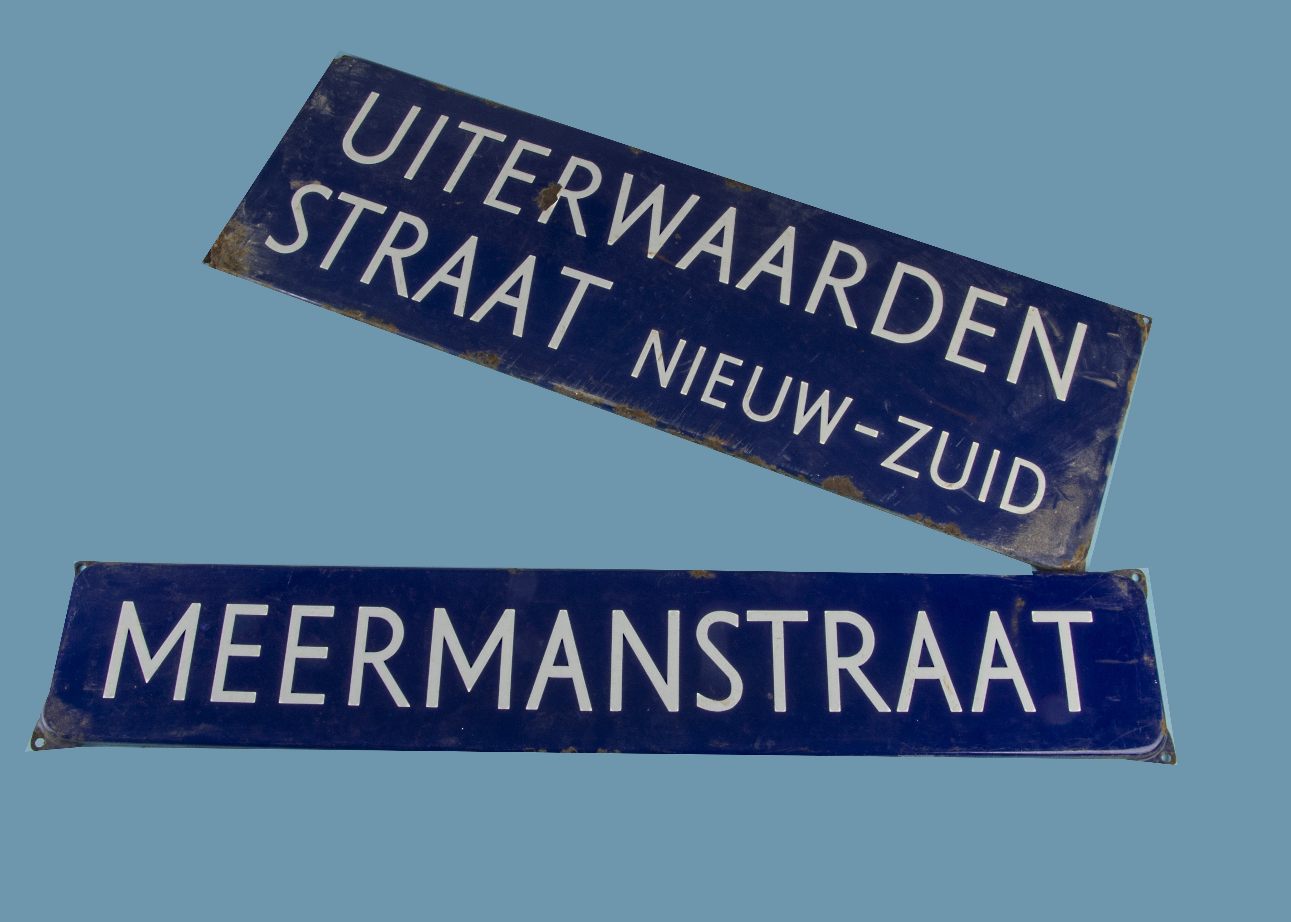 Two vintage Dutch street signs, blue and white and stating "Meermanstraat" and "Uiterwaardenstraat