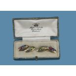 A pair of 18ct gold and enamel motoring interest cufflinks, the Edwardian cigar shaped cufflinks