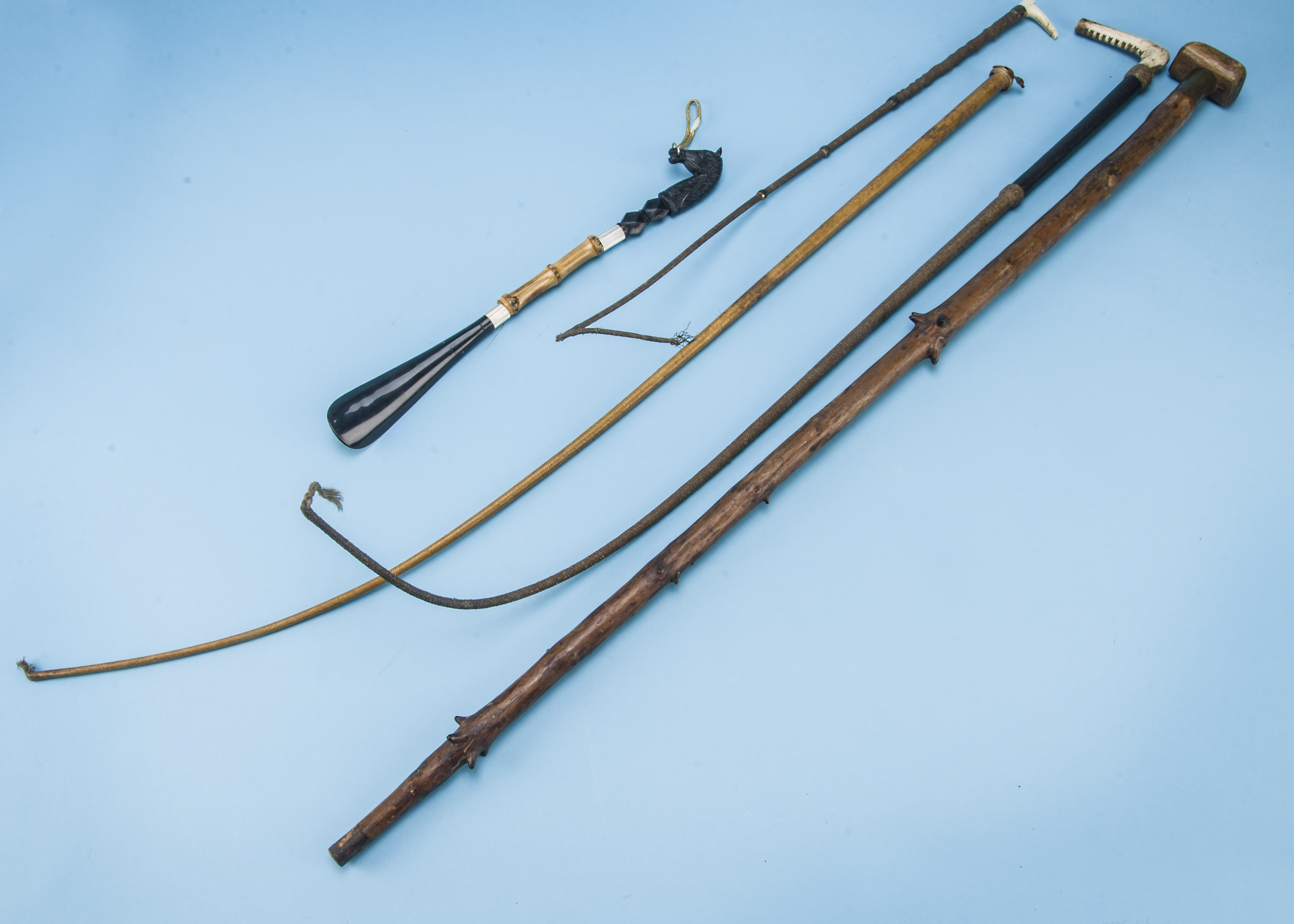 An Edwardian antler and leather bound horse riding crop, together with another smaller example and
