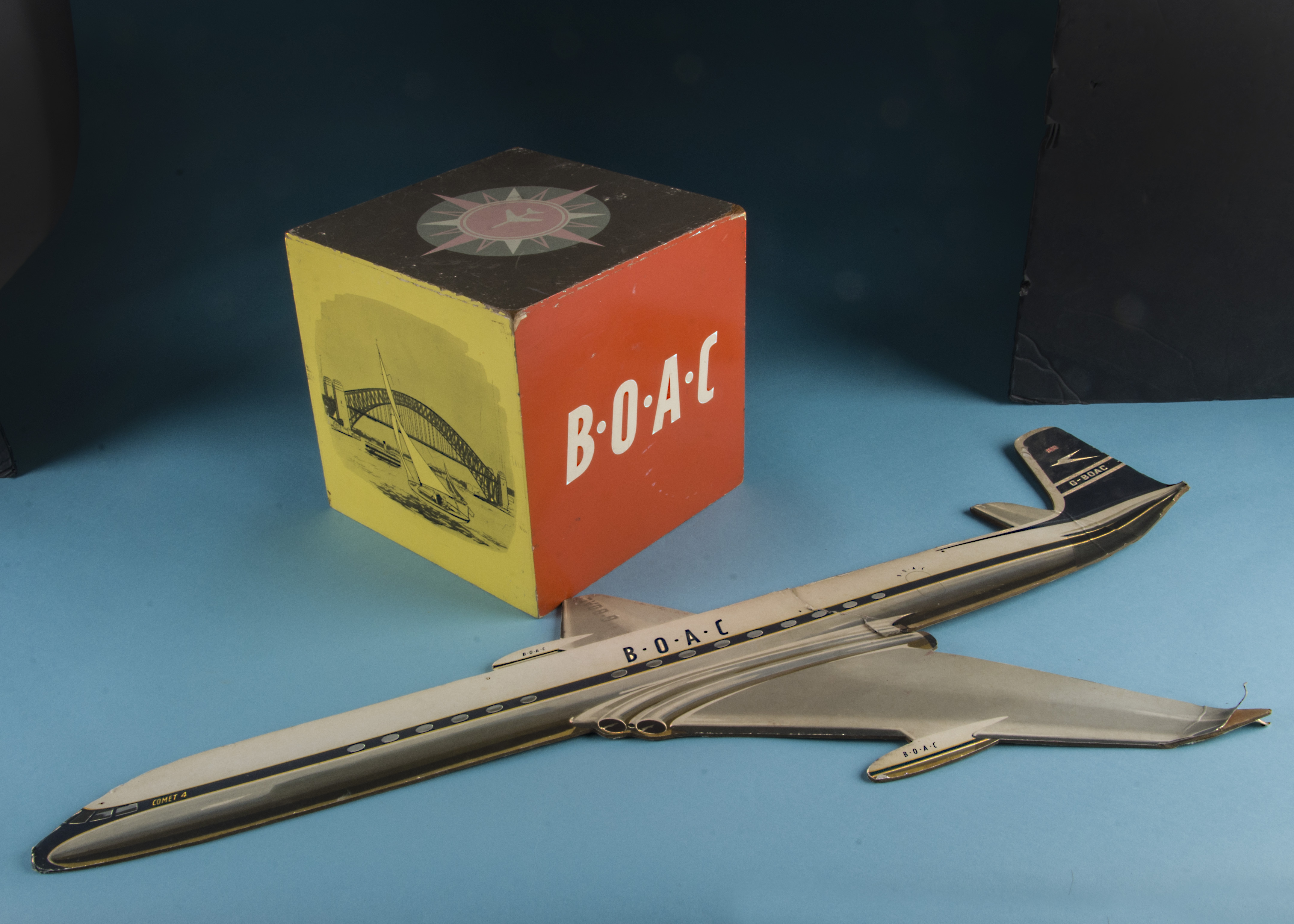 Two 1970s BOAC travel agent display items, including a wooden cube with various designs, 23cm, and a