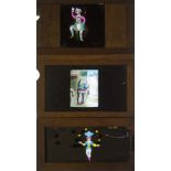 Eight Mahogany-Framed Hand-Coloured Magic Lantern Slipping Slides, of a man falling off a pig, a