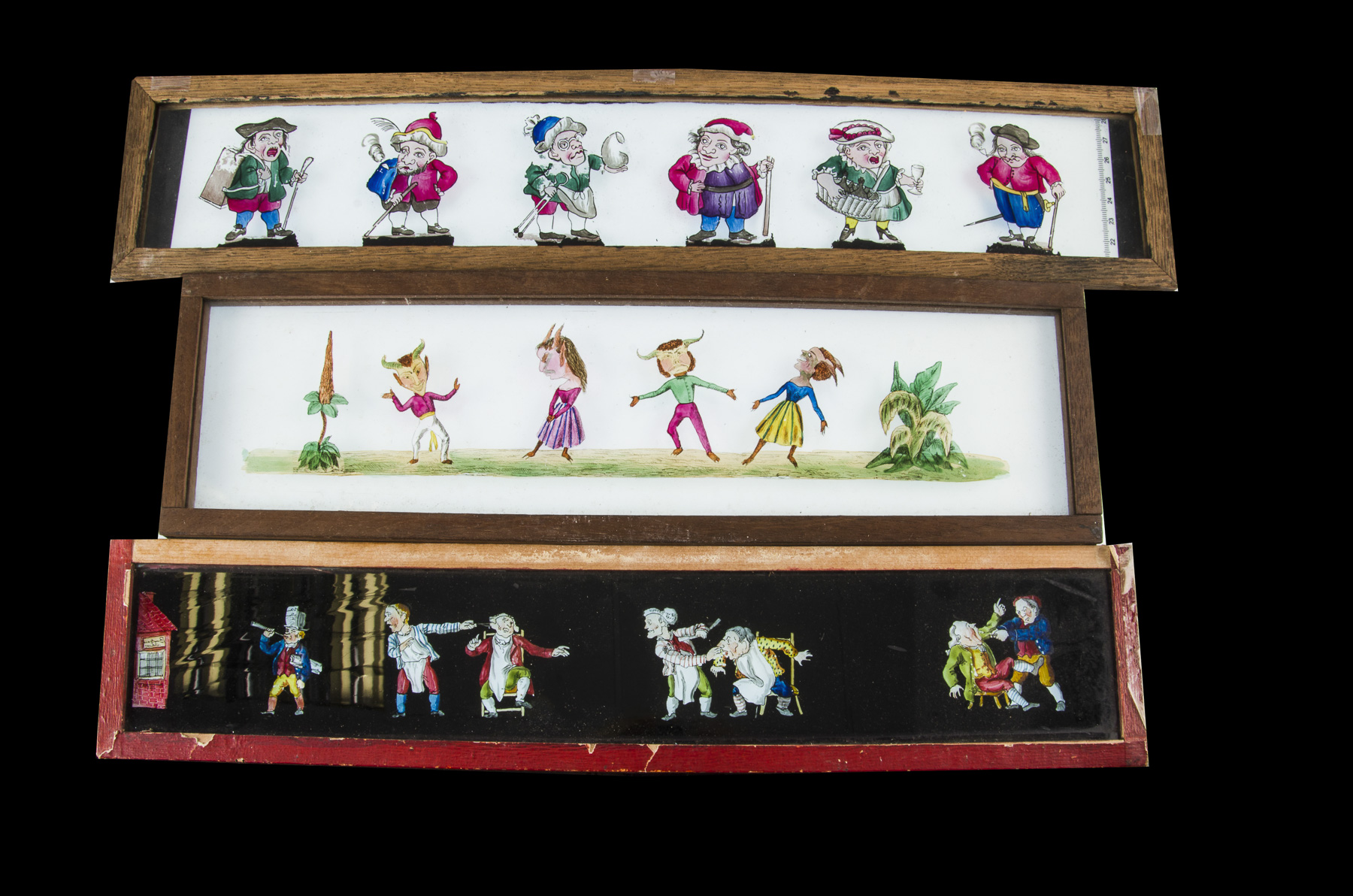 Three Early Mahogany-Framed Hand-Painted Long Procession Slides, one with six figures on including