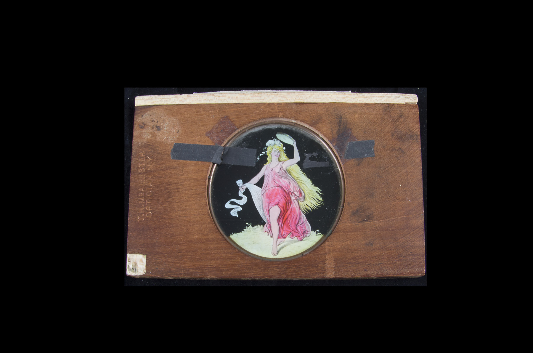 Two Mahogany- mounted Hand-Tinted Magic Lantern Dissolve slides, of a dancing girl with a tambourine