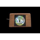 Three Mahogany-Mounted Hand-Coloured Magic Lantern Lever Slides, comprising a man pulling a face,