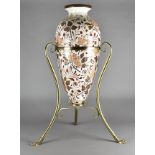 A 19th Century pottery amphora style vase, on ornate brass scroll stand with paw feet, marked to