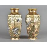 A pair of meiji period faceted vases, decorated with figures signed to base 25 cm high (af)