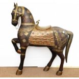 A early 20th Century continental carved wooden horse, modelled standing on three legs with one