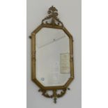 A 19th Century elongated octagonal bevelled glass and gesso framed wall mirror, 76 cm x 35 cm (af)