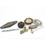 Eight 19th century and later brooches, including a circular agate example with spinning ball to