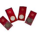 Four 1960s Italian religious medallions, including two matching pairs, one in silver and one bronze,