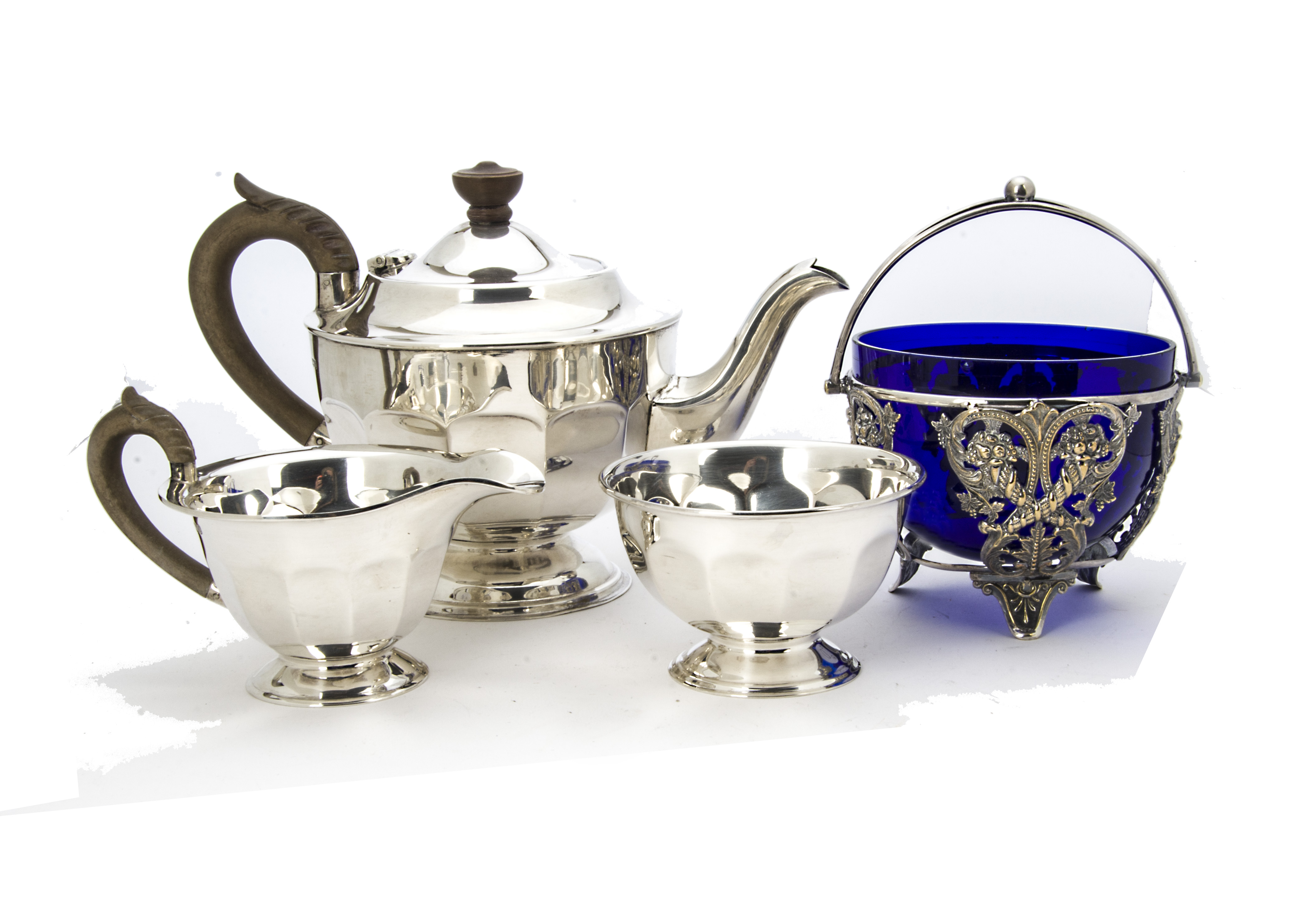An Art Deco period silver three piece tea set by EV, circular with panelled lowers, Sheffield