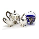 An Art Deco period silver three piece tea set by EV, circular with panelled lowers, Sheffield