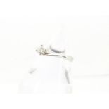 A modern 18ct white gold and diamond solitaire engagement ring, twist style mount, with 0.3ct