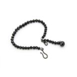 A Victorian jet lady's watch chain, made up of a strand of faceted black beads with hook and watch