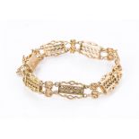 A Victorian 15ct gold bracelet, with fancy pierced panels and knotted links,19.2g, with a safety