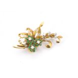 A retro 18ct gold and gem set brooch, in the form of a tied bouquet of flowers and set with emeralds