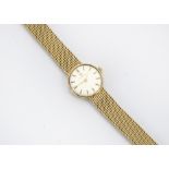 A c1970s Omega 9ct gold lady's wristwatch, circular on an integrated mesh bracelet, 23.8g