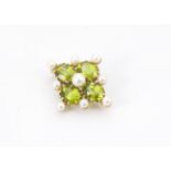 A modern 9ct gold peridot and seed pearl brooch, quatrefoil shaped with four oval green stones, 4.8g