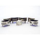 A set of four Victorian silver table salts, two with blue glass liners, together with another