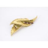 An 18ct gold twin feather brooch, set with rubies and diamonds, marked 750, 8g