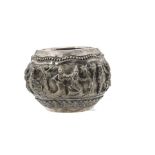 A late 19th or early 20th century Indian white metal bowl, having raised dancing figures within a