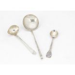 A small Art Deco silver sauce ladle by Georg Jensen, together with a Russian silver spoon and a