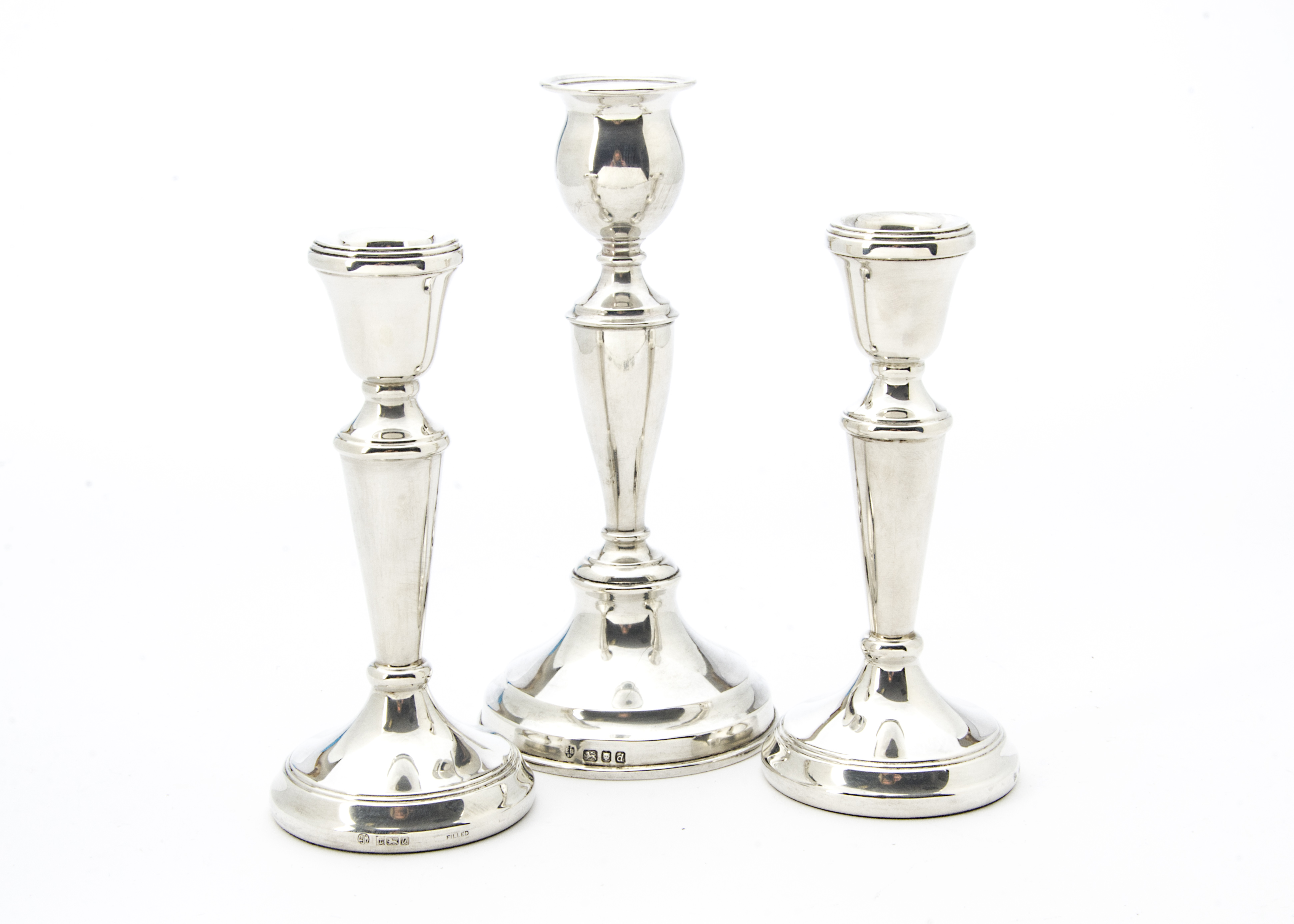 A pair of modern silver filled candlesticks, together with another similar example (3)