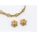 A 14ct gold and diamond bracelet, shaped and pierced panel links, two with old cuts, two settings