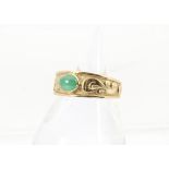 A 1970s Chinese gold and hardstone ring, having a cabochon jade style stone within tapering band,