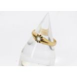 An 18ct gold solitaire gentleman's signet ring, with possibly a white sapphire, 5.4g and V