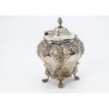 A late Victorian silver tea caddy by George Nathan & Ridley Hayes, the embossed bombe form casket