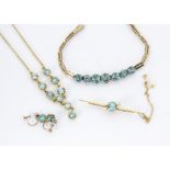 An associated suite of gold and zircon jewellery, comprising a fringe necklace, bracelet, brooch and