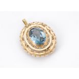 An early 20th century continental gold and aqua marine pendant cum brooch, stepped oval mount with