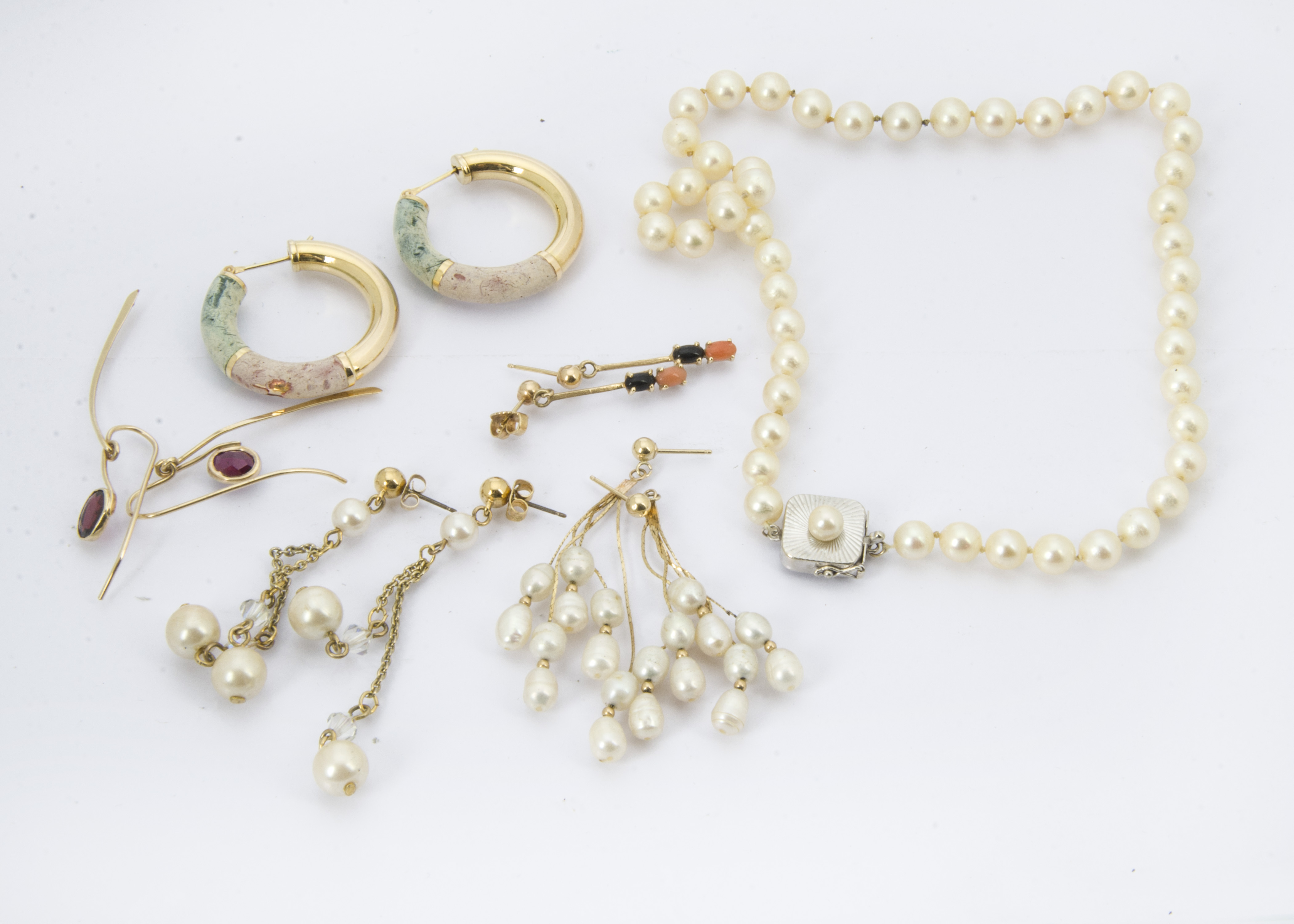 A small group of jewellery, including a pearl necklace, a pair of gold and rice pearl earrings, a