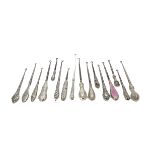 A collection of 16 Victorian and later silver handled button hooks, including one with pink