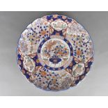 A 1920s Chinese Imari porcelain charger with scalloped edge, with a central vase of flowers and