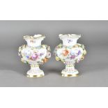 A pair of Meissen porcelain vases, with hand painted and encrusted floral decoration on a white