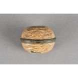 A small hinged enamel pill box in the form of a walnut, 5 cm long