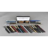 A collection of pens, including two biros with marbled-lacquer bodies with gold reeded decoration,