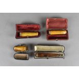 A group of four 19th and early 20th Century amber cheroot and cigar holders, one 15ct gold